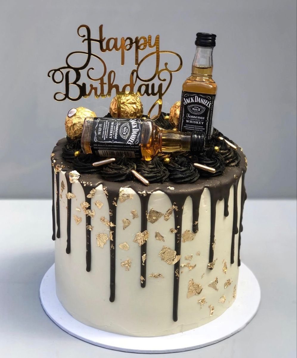 Black cake with chocolate drip and gold leaf